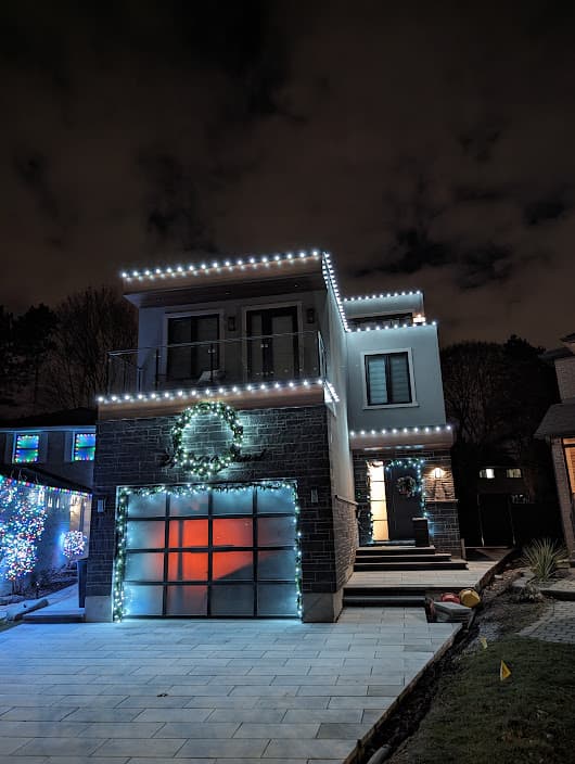Custom Christmas light display on a GTA home at night by GTA Christmas Lighting